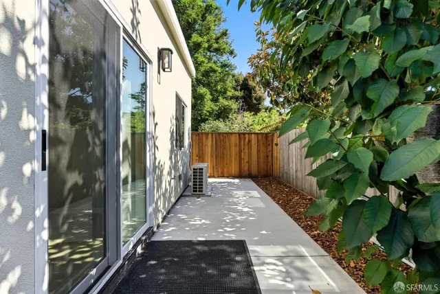 a view of a back yard of the house and a pathway