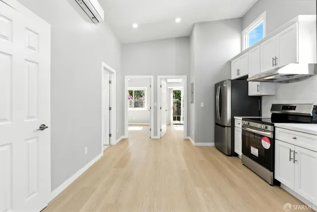 a kitchen with stainless steel appliances a refrigerator sink and cabinets