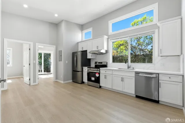a kitchen with stainless steel appliances a refrigerator sink and stove