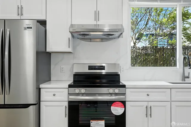 a kitchen with stainless steel appliances a stove and a refrigerator