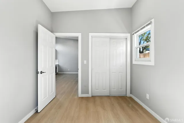 an empty room that has a wooden cupboard