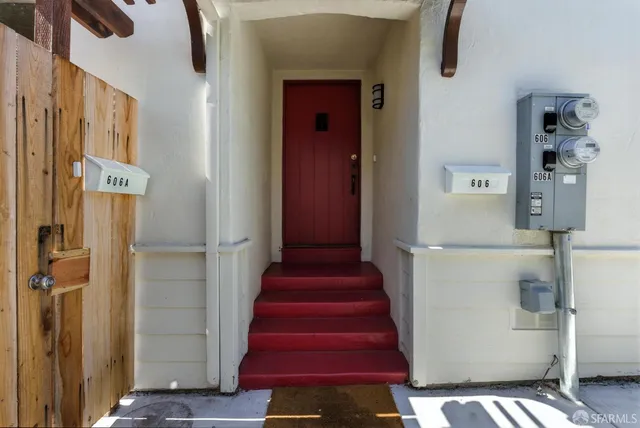 a view of a hallway with wooden floor and entryway