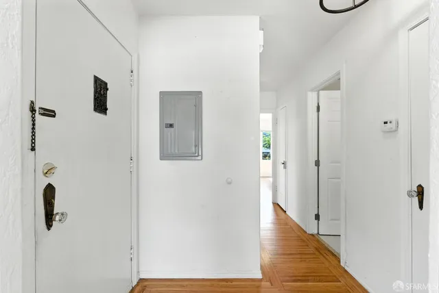 a view of a hallway with wooden floor