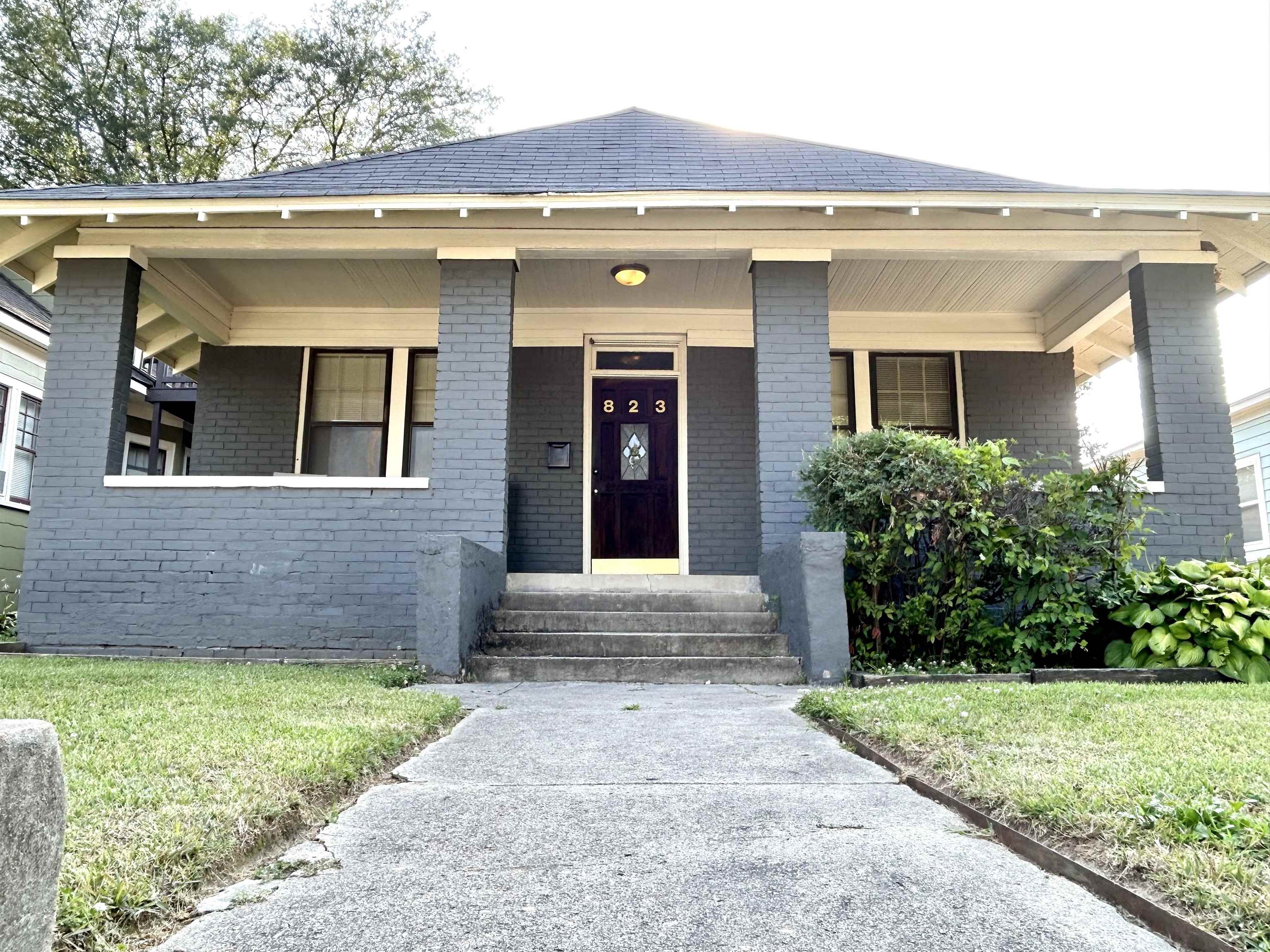 823 Cooper Street Memphis, TN 38104 - Photo 1 of 18 a front view of a house with garden