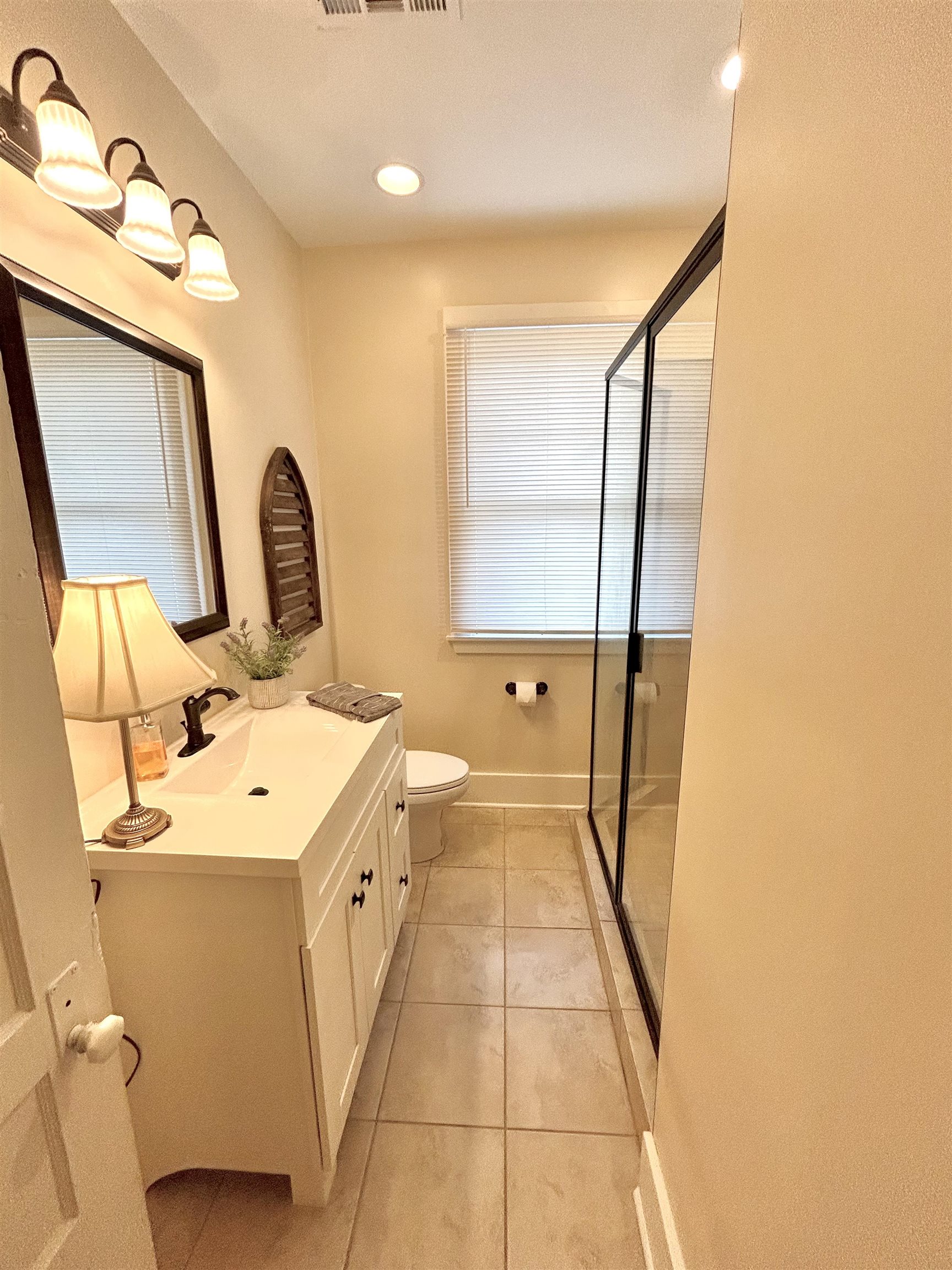 823 Cooper Street Memphis, TN 38104 - Photo 11 of 18 a bathroom with a sink a toilet and mirror