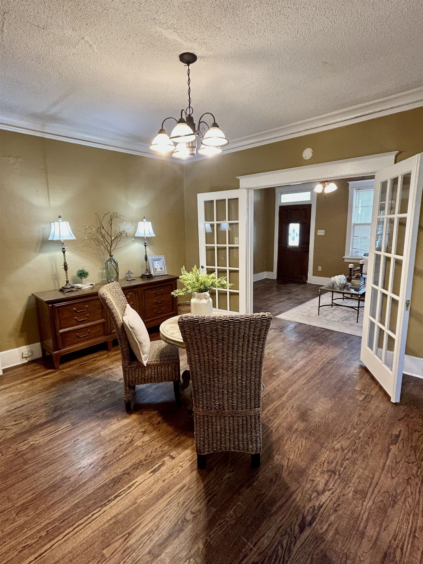 823 Cooper Street Memphis, TN 38104 - Photo 6 of 18 a living room with furniture and a chandelier