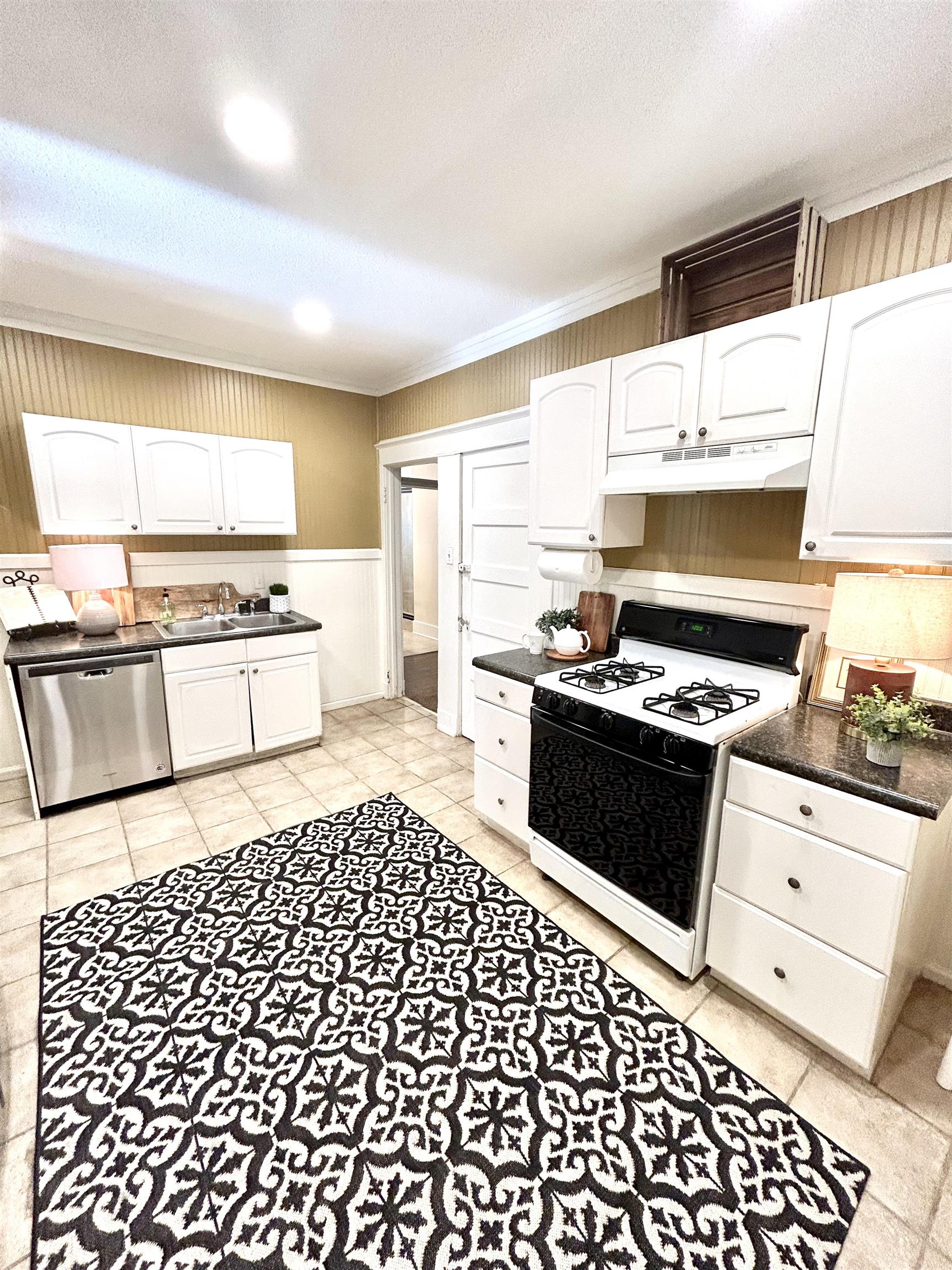823 Cooper Street Memphis, TN 38104 - Photo 8 of 18 a kitchen with a stove a sink and a microwave