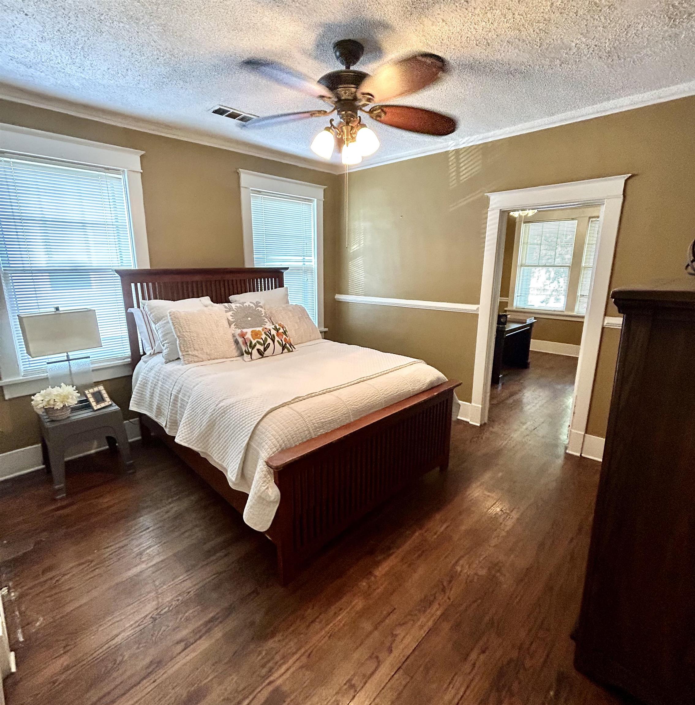 823 Cooper Street Memphis, TN 38104 - Photo 10 of 18 a bedroom with a bed and a chandelier
