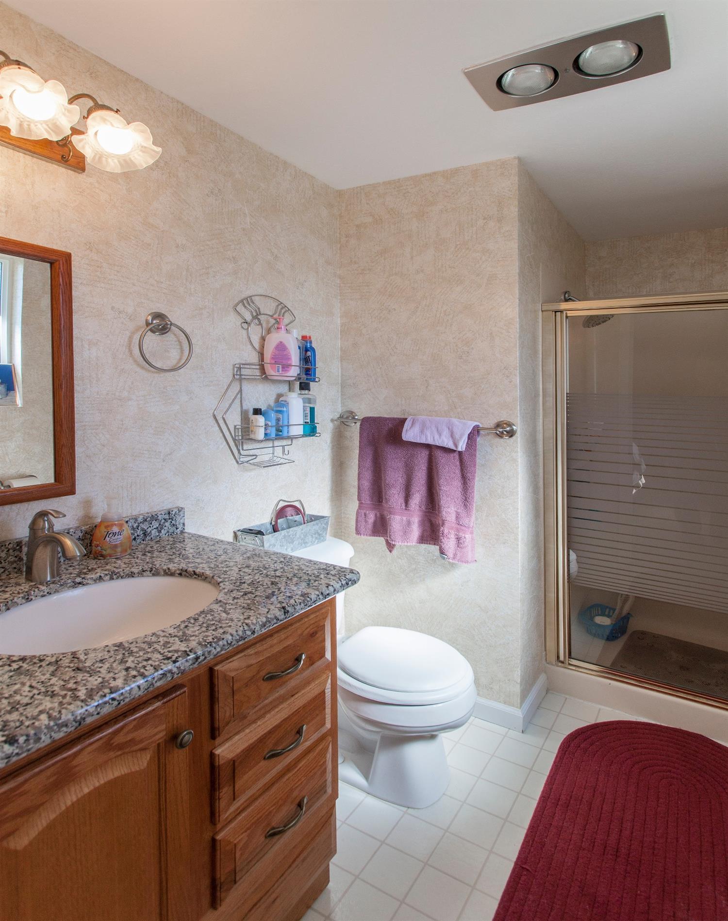 730 Chestnut Street Central Point, OR 97502 - Photo 22 of 23 a bathroom with a granite countertop sink a toilet and a shower