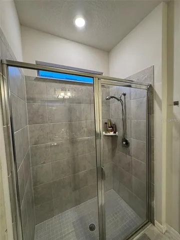 a bathroom with a shower and a sink