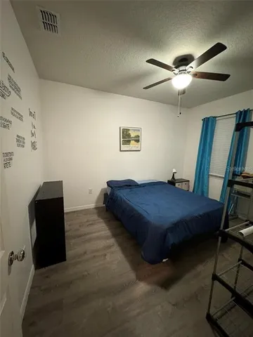 a spacious bedroom with a bed and furniture