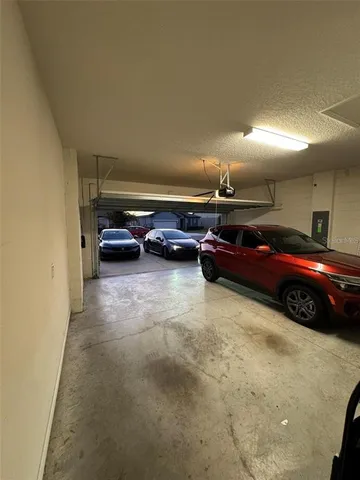 a view of parking garage with cars parked