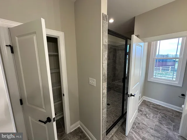 a view of bedroom with a bed and wooden floor