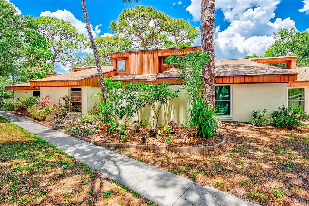 2064 Sunset Point Road, Unit 73 Clearwater, FL 33765 - Photo 42 of 58 a view of a house with a yard and potted plants