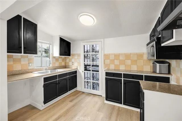 a view of kitchen with cabinets and wooden floor