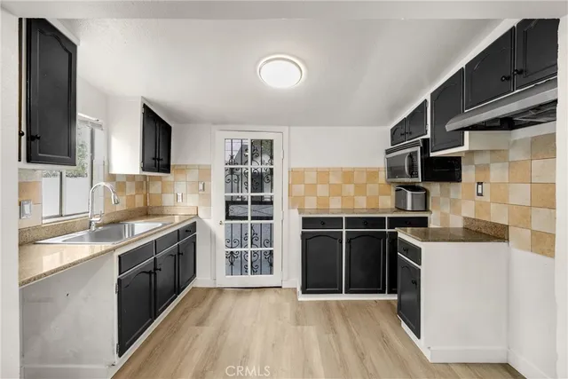 a kitchen with stainless steel appliances granite countertop a stove and a sink