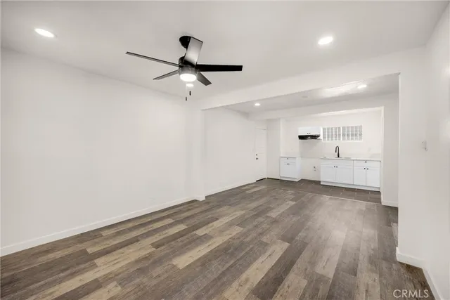 a view of a room with wooden floor and windows