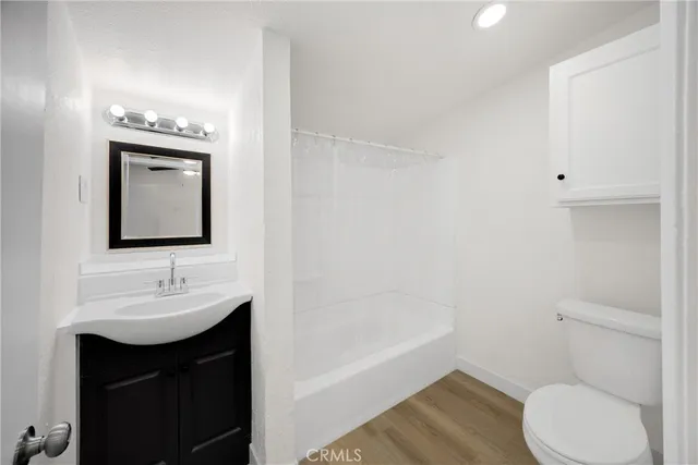 a bathroom with a sink toilet vanity and tub