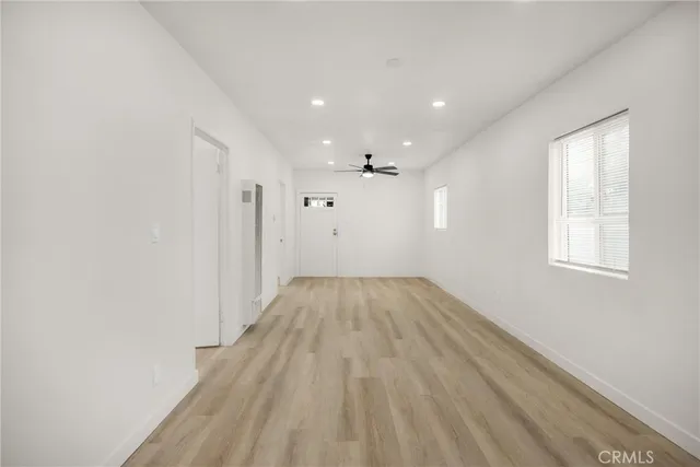 a view of a room with wooden floor and window