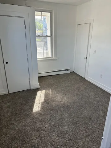 an empty room with a empty space and a window