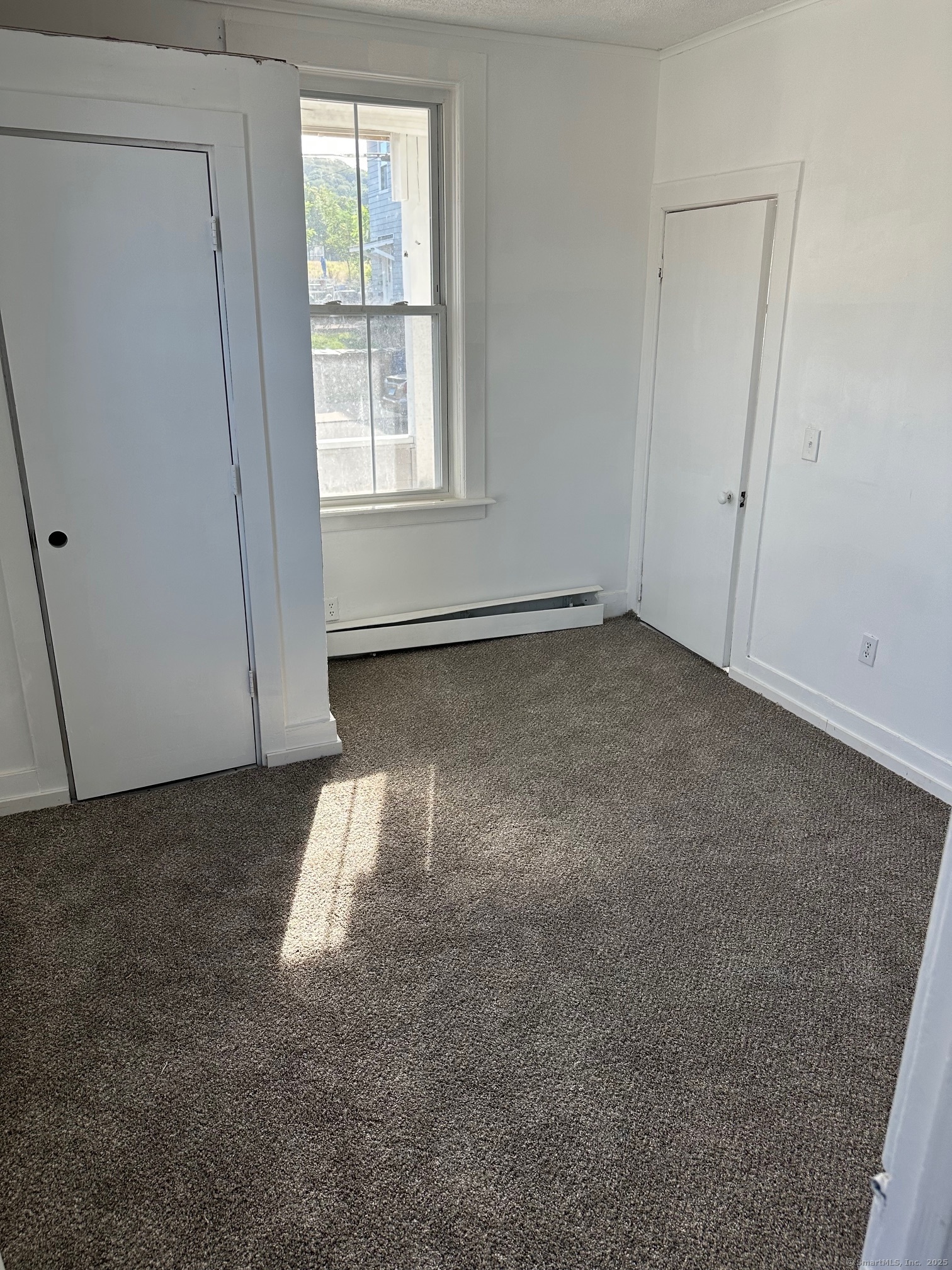 23 Ward Street, Unit 2 Vernon, CT 06066 - Photo 6 of 9 an empty room with a empty space and a window