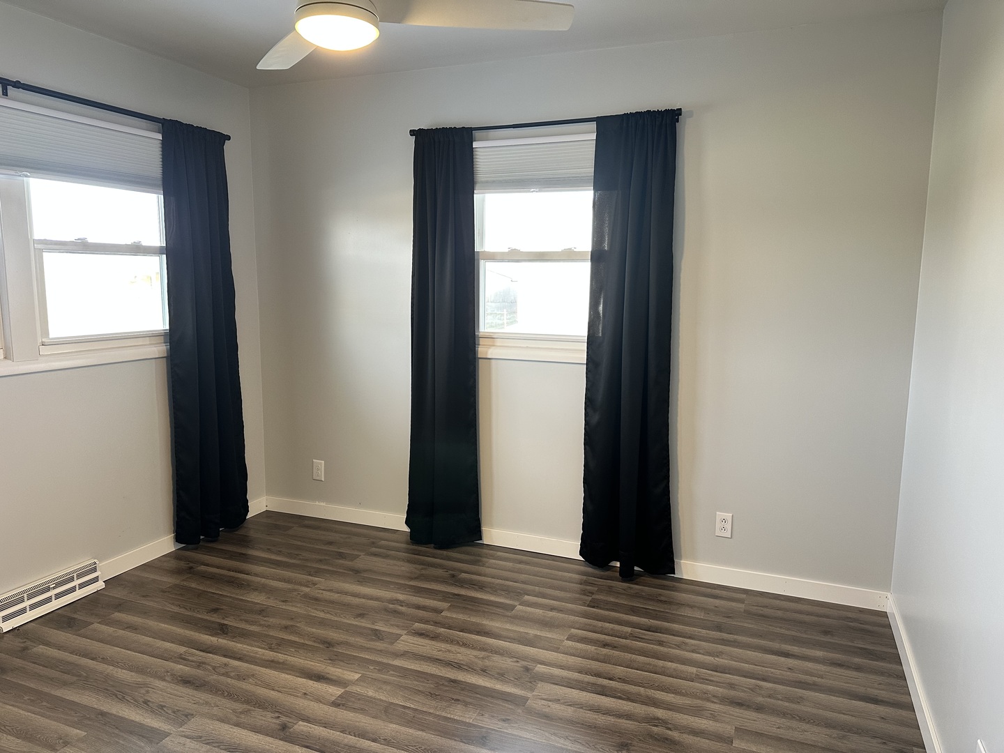 402 West South Street Preston, IA 52069 - Photo 15 of 21 an empty room with wooden floor and windows