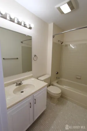 a bathroom with a tub shower and a sink