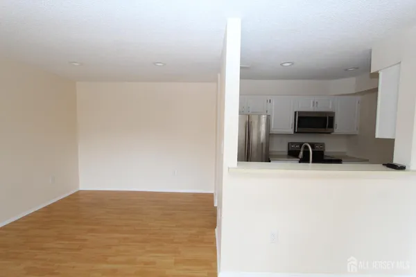 a view of a kitchen with microwave and furniture
