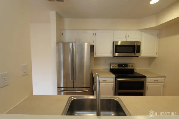 a view of refrigerator and microwave