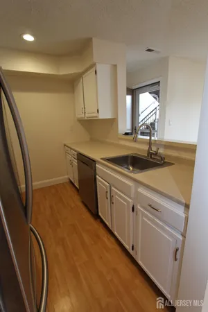 a view of a room with wooden floor and a window