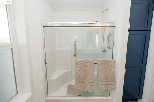 a bathroom with a glass shower door