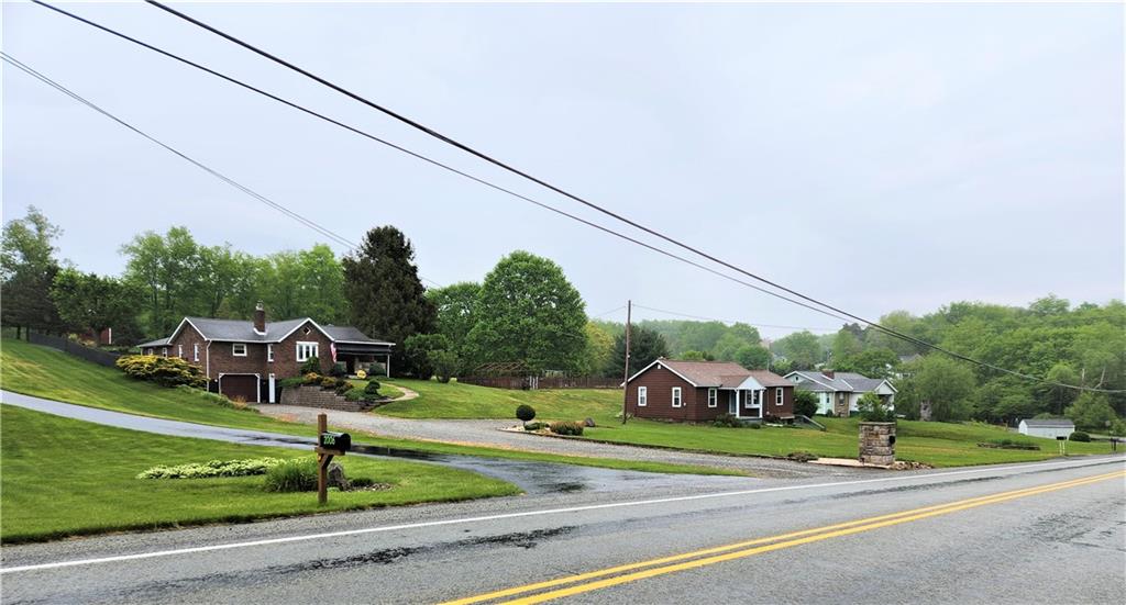 0 State Route 908/millerstown Road Natrona Heights, PA 15065 - Photo 2 of 11 a view of a house with a big yard and potted plants