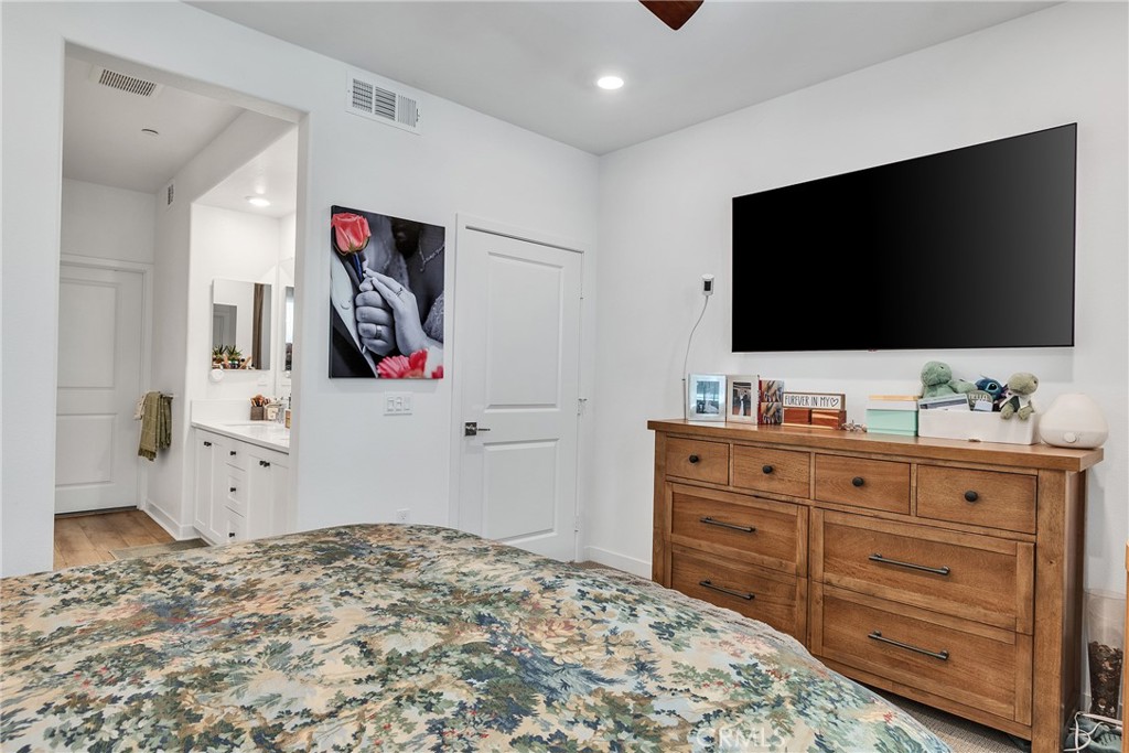 1200 Lasso Way, Unit 105 Rancho Mission Viejo, CA 92694 - Photo 10 of 43 a bedroom with a bed and a flat screen tv in it