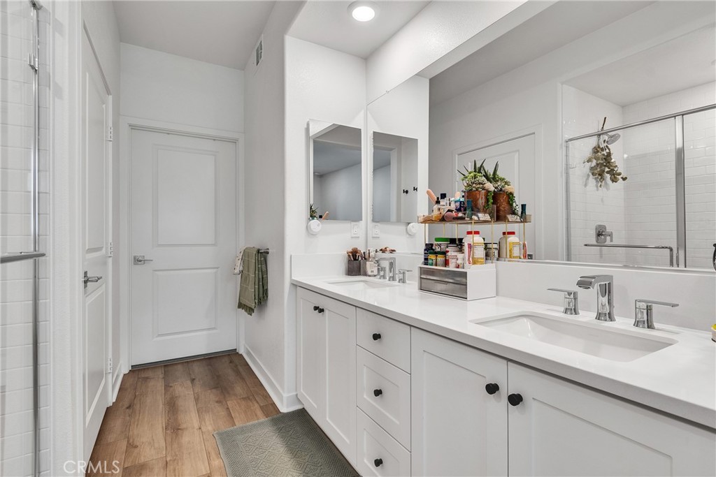 1200 Lasso Way, Unit 105 Rancho Mission Viejo, CA 92694 - Photo 12 of 43 a spacious bathroom with a double vanity sink and mirror