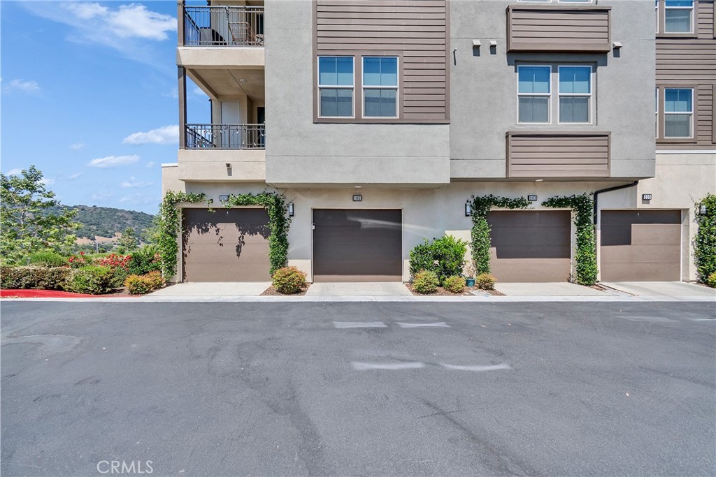 1200 Lasso Way, Unit 105 Rancho Mission Viejo, CA 92694 - Photo 17 of 43 a front view of a house with a yard and a garage