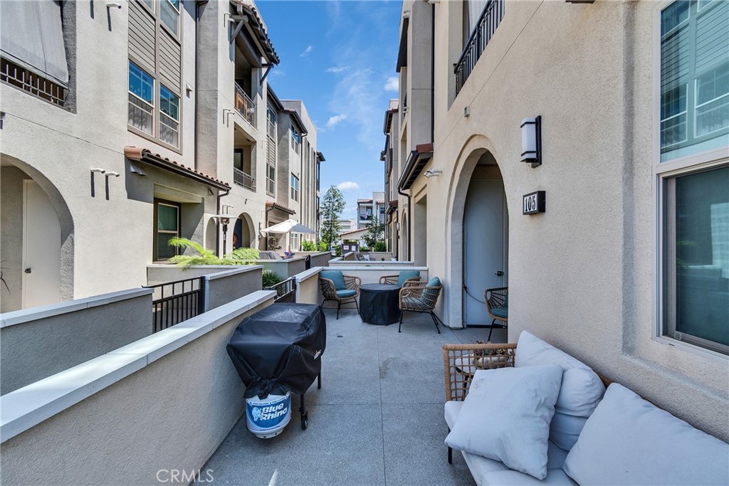 1200 Lasso Way, Unit 105 Rancho Mission Viejo, CA 92694 - Photo 24 of 43 a living room with patio furniture and a window