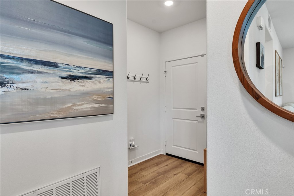 1200 Lasso Way, Unit 105 Rancho Mission Viejo, CA 92694 - Photo 25 of 43 a view of a hallway with wooden floor