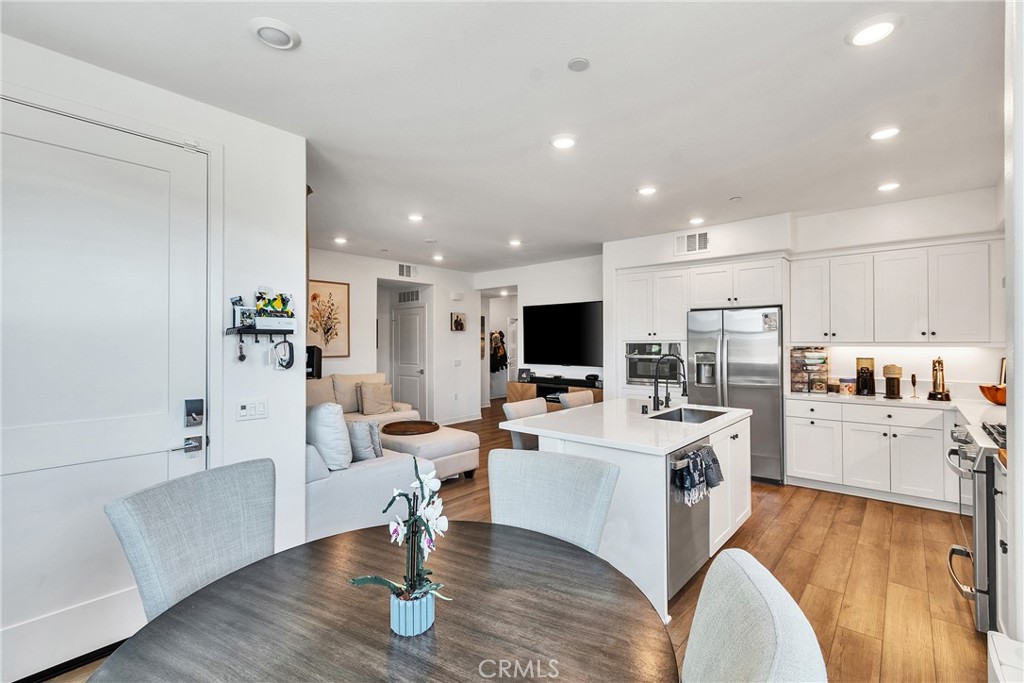 1200 Lasso Way, Unit 105 Rancho Mission Viejo, CA 92694 - Photo 7 of 43 a living room with stainless steel appliances furniture and a flat screen tv