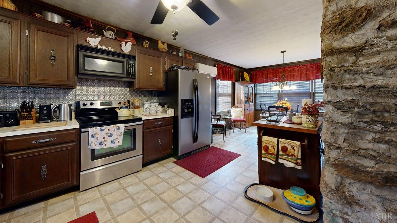426 Burgess Road Madison Heights, VA 24572 - Photo 15 of 51 a kitchen with stainless steel appliances granite countertop a stove a sink dishwasher and cabinets with wooden floor
