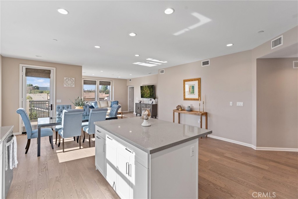 260 Buena Vida Drive, Unit 301 Brea, CA 92823 - Photo 10 of 50 a view of kitchen island kitchen island dining table and wooden floor