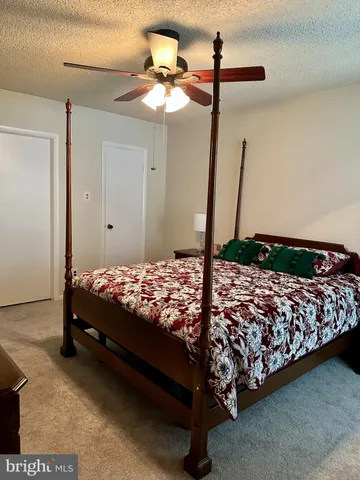 a bed sitting in a bedroom next to a lamp