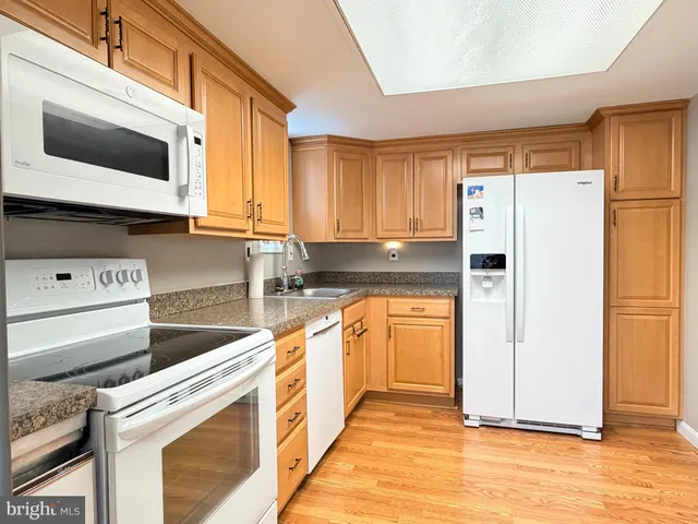 a kitchen with stainless steel appliances white cabinets and a refrigerator