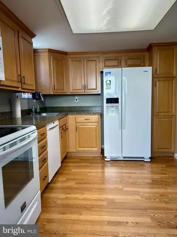 a kitchen with stainless steel appliances granite countertop a refrigerator sink and cabinets