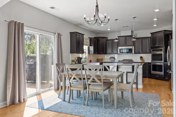 a kitchen with granite countertop a sink stainless steel appliances and cabinets