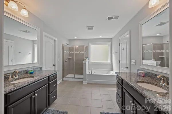 a bathroom with a glass shower door and a bathtub