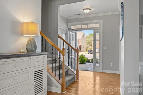 a view of staircase with wooden floor and windows