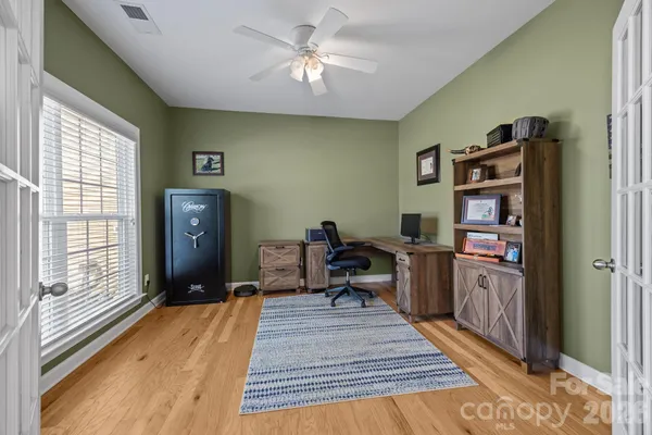 a living room with furniture window and wooden floor