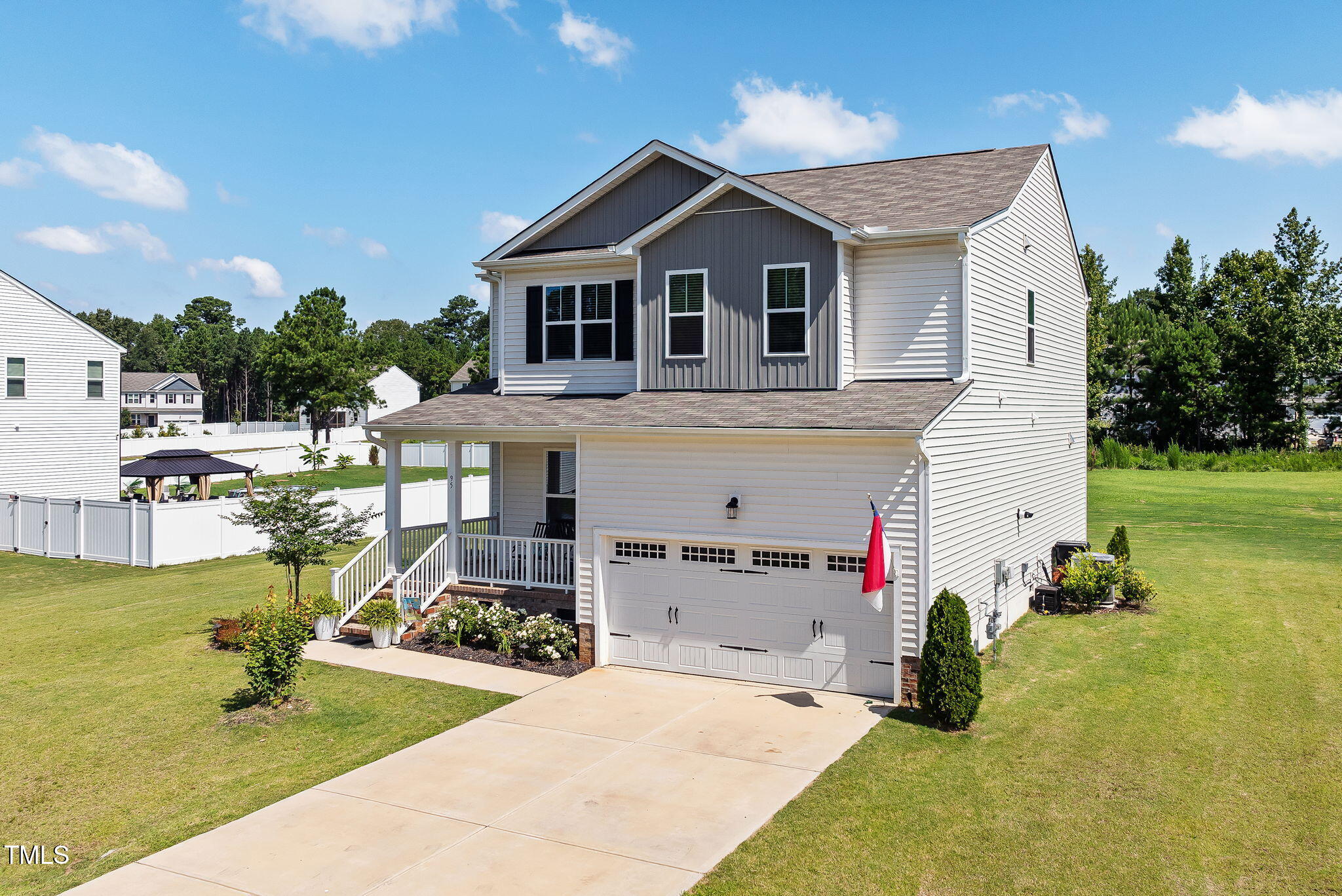 a front view of a house with a garden and swimming pool