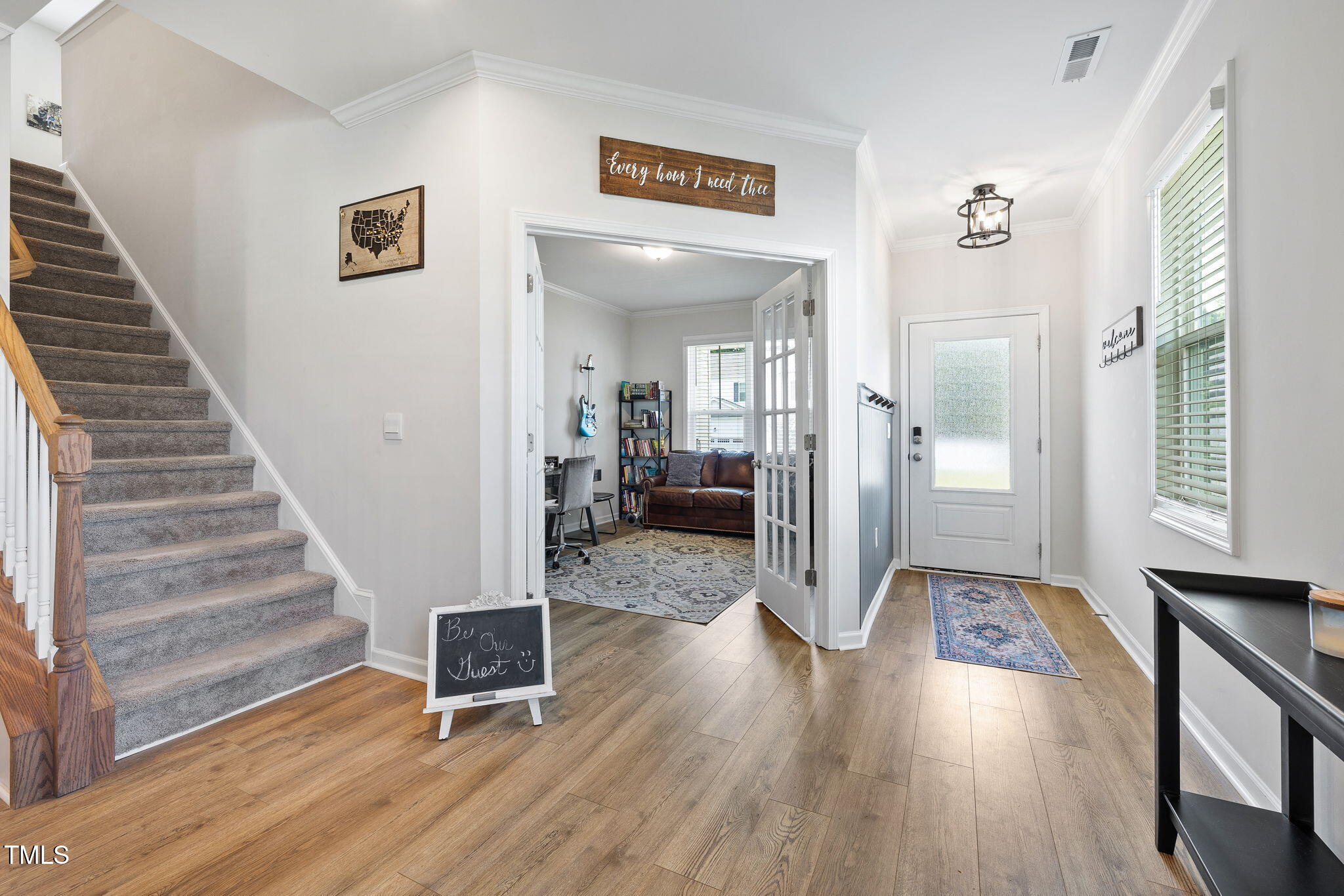 95 Madden Rose Loop Garner, NC 27529 - Photo 11 of 51 a view of a hallway with wooden floor and staircase