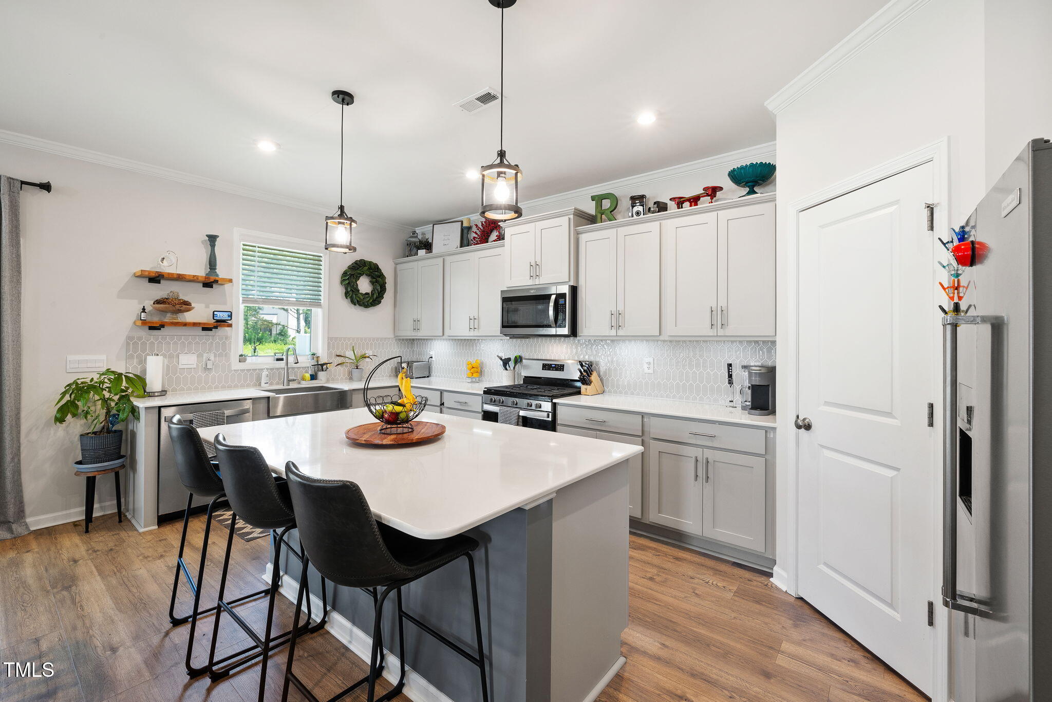 95 Madden Rose Loop Garner, NC 27529 - Photo 18 of 51 a kitchen with stainless steel appliances kitchen island granite countertop a table chairs and a refrigerator